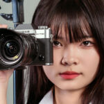 Best Fujifilm Cameras for Portraits - A woman holding a Fujifilm camera