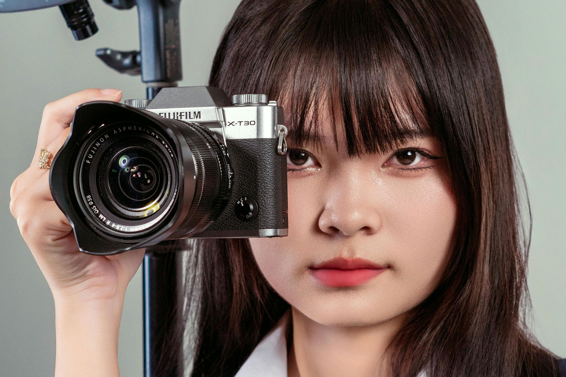 Best Fujifilm Cameras for Portraits - A woman holding a Fujifilm camera